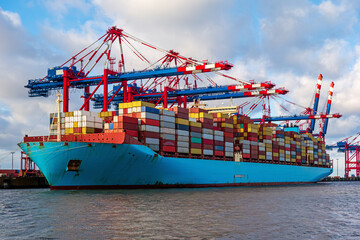 Fototapeta premium Container ship loading and unloading in port. Logistic import and export freight transportation by container ship.