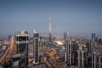 Fototapeta na wymiar Evening Millenium Tower and Burj Khalifa, Executive Towers at night, Burj Khalifa - skyscraper in height of 828 meters in Dubai, tallest structure in world