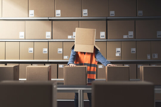 Frustrated warehouse worker with a box on her head