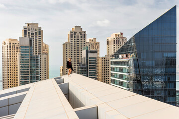 Woman on roof near Silverene Tower RMJM (on right), Designed by RMJM, this complex offers 35 floors in Tower A and 26 floors in Tower B