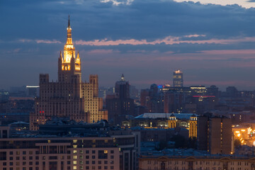 Fototapeta premium Tall residential building on square Kudrinskaya (Stalin skyscraper) at night in Moscow, Russia