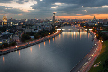 Borodinsky bridge with illumination on Moskva river in evening in Moscow, Russia