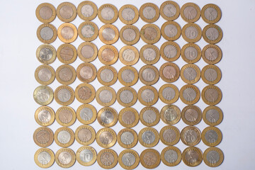 Top view of Indian ten rupee coins currency texture on white background