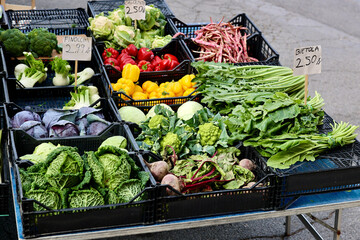 Boxes with fresh vegetables for sale at Italian market. Weekly food market in San Quirico d'Orcia, Province of Siena, Tuscany, Italy.