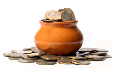 Coins in a clay pot on a white background, money saving concept.
