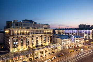 Fototapeta na wymiar (long exposure) Tverskaya street (main street) of Moscow. Ritz-Carlton hotel at evening