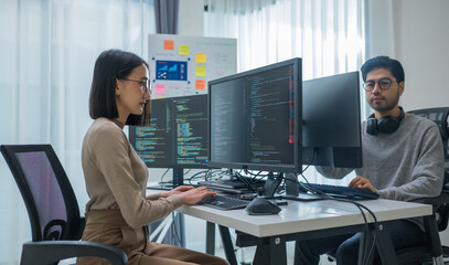 asian woman  and Indian man Developer team working  about programming software data online at office - 755745791