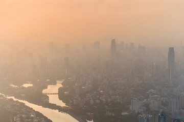 Skyscrapers of Guangzhou city, Zhujiang river among mist, China, aerial view