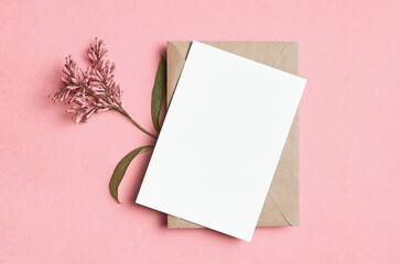 Blank greeting or invitation card mockup with envelope and lilac flowers, white card with copy space