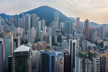 Residential buildings in sleeping area near green mountain in Hong Kong, China, view from China Merchants Tower