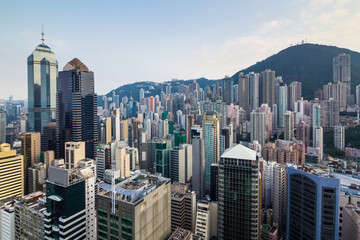 Residential buildings and modern office buildings near green mountain in Hong Kong, China, view...