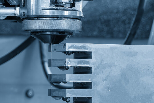 Closeup scene the wire EDM machine cutting the mold insert parts.