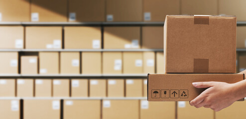 Warehouse worker holding delivery boxes