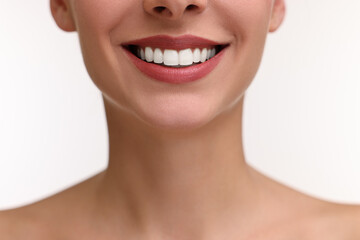 Woman with beautiful lips smiling on white background, closeup