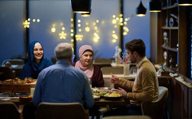 A modern and traditional European Islamic family comes together for iftar in a contemporary...