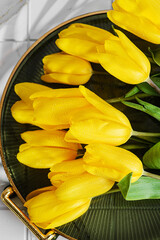 yellow tulips on a tray