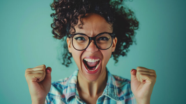 Portrait of a woman elated with success fists raised screaming 'yeah' embodying the joy of her victory