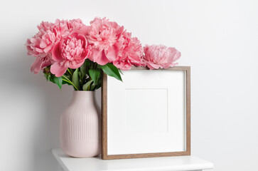 Square artwork frame mockup with peony flowers in white interior