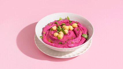 Beetroot hummus on pink background