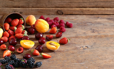 assortment of fresh berries on wooden background