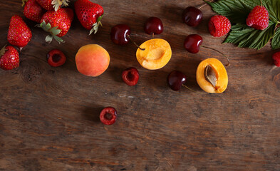 assortment of fresh berries on wooden background