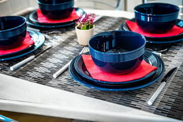 Close-up of Dark Blue  Ceramic Tea Cups and Matching Plates  Eleganlty Arranged on the Table. Ideal...