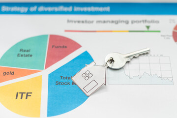 Property finance business concept image for financial market. House key on graphic charts