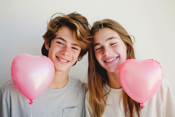 Fototapeta na wymiar a closed mouth smiling teenager couple with a heart shaped balloon on white background 