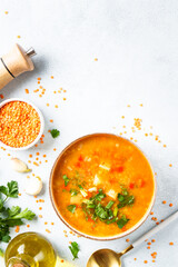 Red lentil soup, traditional middle eastern food on white background. Top view with space for design.