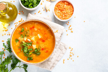 Red lentil soup, traditional middle eastern food on white background. Top view with space for design.