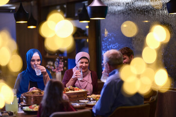 A modern and traditional European Islamic family comes together for iftar in a contemporary restaurant during the Ramadan fasting period, embodying cultural harmony and familial unity amidst a