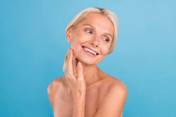 Photo of dreamy cute elderly lady naked shoulders enjoying soft skin arms touch cheekbones isolated blue color background - 755774728