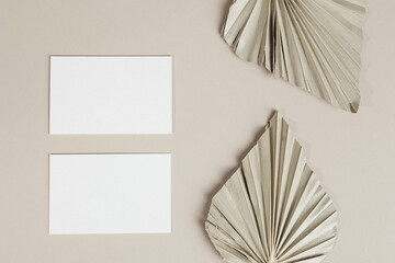 Blank business cards with dried palm leaves