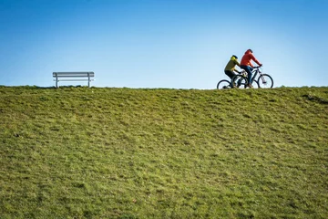 Tuinposter cyclist on a grass near cuxhaven © WD Suncrest