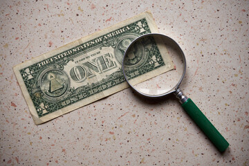 US dollar, magnifying glass