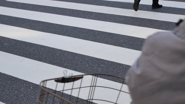 low angle view to the asphalt street at zebra crossing area at intersection while crowded of people pedestrian walking crossing ginza shopping street in Tokyo