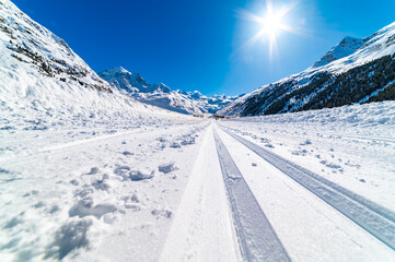 Val Roseg, in Engadine, Switzerland, in winter, with snow-covered cross-country ski slopes.