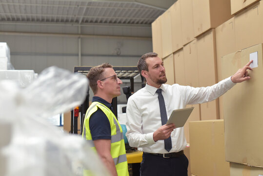 Workerand Manager in a warehouse in the logistics sector - transport and processing of orders in trade