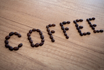 The word coffee formed from roasted coffee beans. Cup of delicious coffee is a perfect source of energy in the morning, at lunch and in the evening. - obrazy, fototapety, plakaty