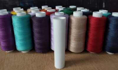 colorful spools of thread for embroidery close up background