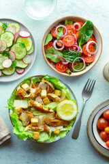 Fresh salads, overhead flat lay shot of an assortment. Caesar salad with chicken breast, tomato salad with leaves, cucumber and radish, healthy food, top shot - 755791529