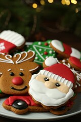 Different tasty Christmas cookies on white plate, closeup. Space for text