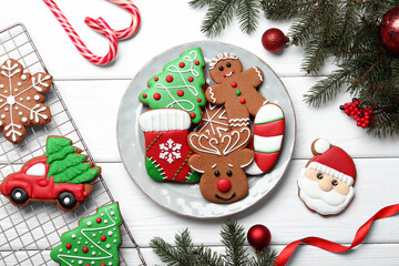 Tasty homemade Christmas cookies and decor on white wooden table, flat lay