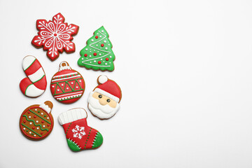 Fototapeta na wymiar Different tasty Christmas cookies on white background, flat lay. Space for text