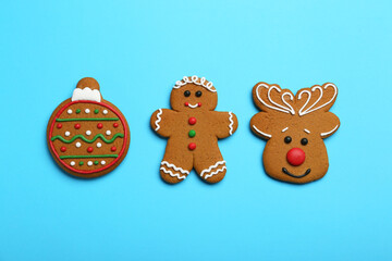 Fototapeta premium Different tasty Christmas cookies on light blue background, flat lay