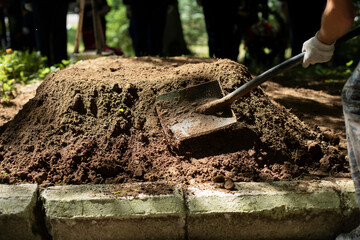 Digging up soldier's grave. Funeral of military. Reburial of World War II soldier.