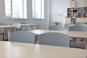 Fototapeta na wymiar Empty school classroom with desks and chairs