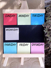 Sunday Monday Tuesday Wednesday Thursday Friday Saturday. Days on multicolor paper background. Calendar concept.

