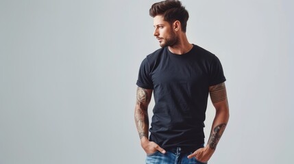 Refined man wearing a short-sleeved, plain black t-shirt and stylish blue jeans