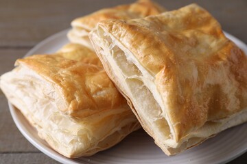 Delicious fresh puff pastries on table, closeup